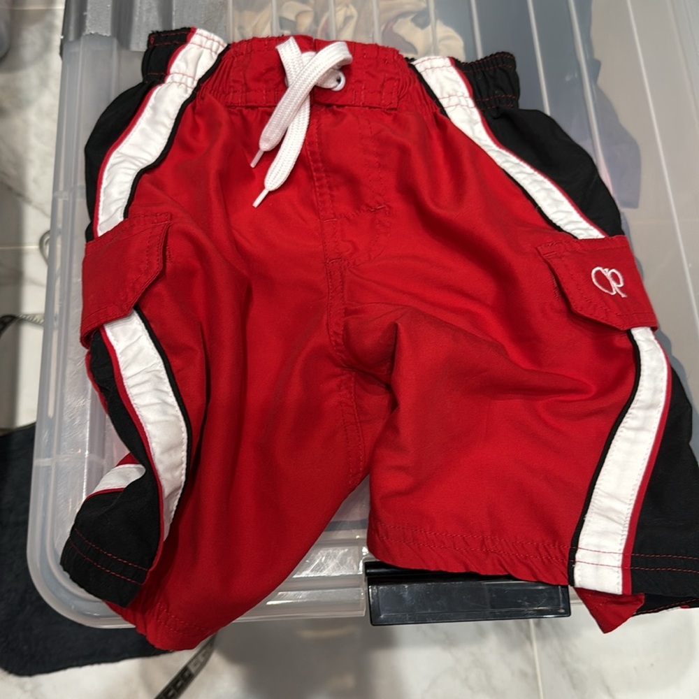 Size 4/5 boy’s. oP red black & white swimtrunks